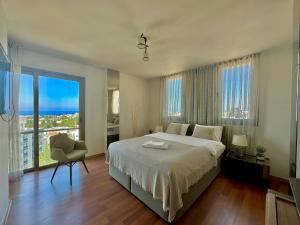 a bedroom with a large bed and a large window at Magic Vista Exclusive Luxury Duplex by HolidayKeys in Kérynia