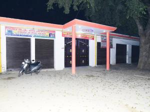 a scooter parked in front of a building at Hotel Naimisharanya Rameshwaram Dham in Naimishāranya