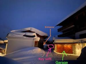 a house covered in snow at night at Penthouse Wöster in Lech am Arlberg
