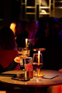 a table with a glass of wine on it at Khai Karaköy in Istanbul +39 photos