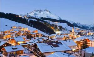 a view of a town in the snow at night at Appartement Kriegerhorn in Lech am Arlberg