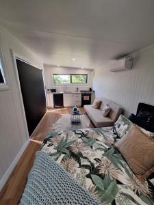 a living room with a couch and a table at Hidden Gem in Te Awamutu