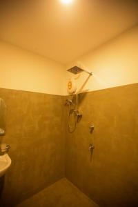 a shower stall in a bathroom with a sink at The Coconut Garden Villa Unawatuna in Unawatuna