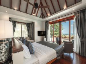 a bedroom with a large bed and a large window at Baan View Talay - Sea View Zenith Villa By Elite Havens in Surin Beach +38 photos