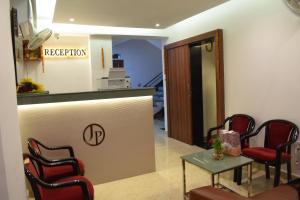 a waiting room with a counter and chairs and a table at Hotel Deluxe in Rānchī