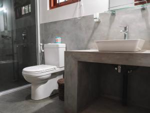 a bathroom with a toilet and a sink and a shower at The Other Corner Habarana in Habarana +53 photos