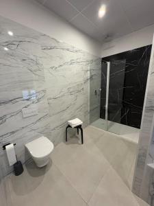 a bathroom with a toilet and a shower at Centric Loft near Arts & Science in Valencia +12 photos