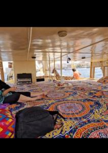 two people laying on the floor of a boat at Nile Bride Felucca in Aswan