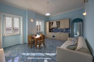 a living room with a couch and a table at Perla Marina - HelloElba in Portoferraio