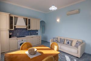 a living room with a couch and a table at Perla Marina - HelloElba in Portoferraio +17 photos