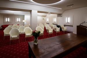 a room with a bunch of chairs and a table at Eurohotel in Piacenza