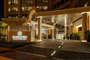 a building with a sign that reads sheraton headquarters at Sheraton Mall of the Emirates Hotel, Dubai in Dubai