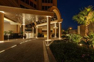 a building with lights on it at night at Sheraton Mall of the Emirates Hotel, Dubai in Dubai