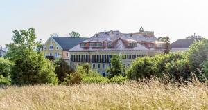 a large building in the middle of a field at Hotel Stiegl-Gut Wildshut in Wildshut