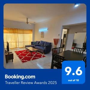 a living room with a couch and a table at Bintara Guesthouse Sri Sayang Batu Ferringhi in Batu Ferringhi