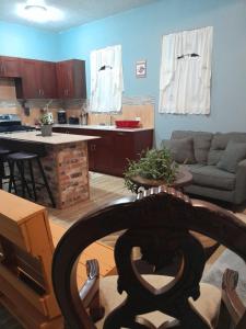 a kitchen and living room with a couch and a table at Abigail's Spectacular 2 bedrooms-Entire Apartment in Tortola Island