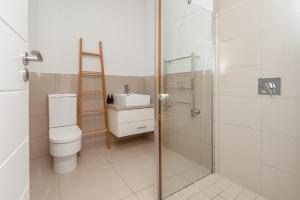 a bathroom with a toilet and a sink and a shower at Island lifestyle on the water in Knysna +29 photos
