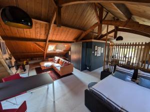 a large living room with wooden ceilings and a couch at Hofstede Prinsland in Kortgene