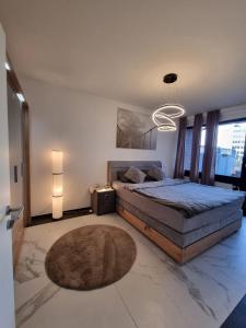 a bedroom with a large bed and a rug at Hafenperle in Bad Zwischenahn