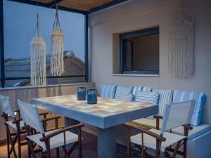 a dining room with a table and chairs at Elegant City Apartment - 250m from Solomos Square in Zakynthos Town