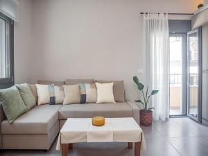 a living room with a couch and a table at Elegant City Apartment - 250m from Solomos Square in Zakynthos Town +38 photos