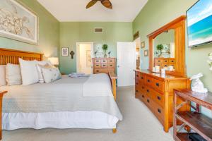 a bedroom with a bed and a dresser and a mirror at Coastal Lakehouse Condo on Siesta Key Public Beach in Sarasota +32 photos