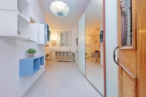 a hallway with a door leading to a living room at San Paolo's apartment in Rome +33 photos