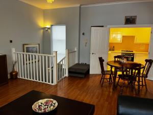 a living room with a table and a kitchen at Keysan House in London