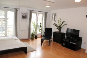 a bedroom with a bed and a flat screen tv at Erkel Apartment in Budapest