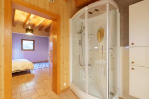 a bathroom with a shower and a bed in a room at Chalet La Rayée - Vue lac et montagne 14p in Gérardmer +16 photos