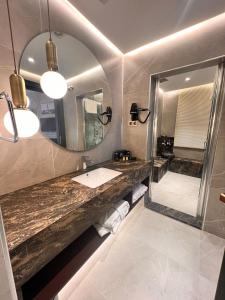 a bathroom with a sink and a mirror at Sur Royal's Hotel in Diyarbakır +41 photos