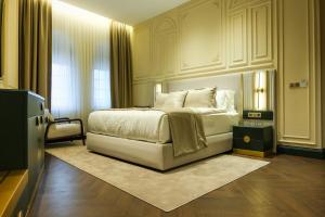 a bedroom with a white bed and a window at Sur Royal's Hotel in Diyarbakır
