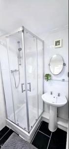 a bathroom with a shower and a sink at Arnstone Spacious 6 bedroom home with parking in Hythe