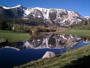 a reflection of a mountain in a lake at Snowcreek Resort Vacation Rentals in Mammoth Lakes