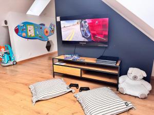 a living room with a flat screen tv on a wall at Chalupa Martinček in Terchová