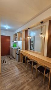 a kitchen with a long wooden table in a room at Bacolod Studio Condo Unit in Bacolod