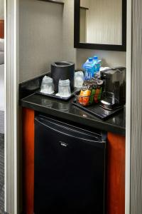 a kitchen with a black counter top and a dishwasher at Courtyard by Marriott San Antonio Six Flags at The RIM in San Antonio