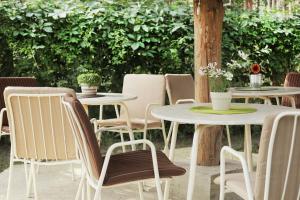a group of tables and chairs in a yard at Vila Dunavski Raj in Golubac