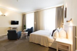 Giường trong phòng chung tại Unitas Hotel