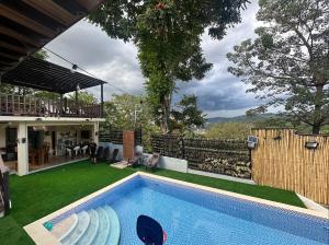 a backyard with a swimming pool and a house at Mountain View at Fuji St Antipolo in Antipolo