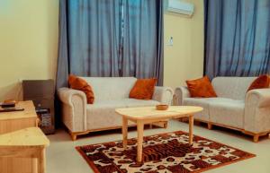 a living room with two couches and a coffee table at Dodoma Central Apartments in Dodoma