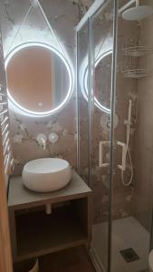 a bathroom with a sink and a shower at La Maison De Poupée in Bari