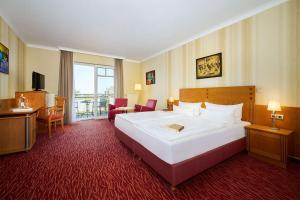 Ein Bett oder Betten in einem Zimmer der Unterkunft Strandhotel Prinz von Preussen
