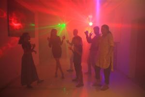 a group of people dancing in a room with lights at Parampara Resort & Spa, Coorg in Kushālnagar