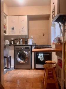 a kitchen with a washing machine and a counter at Beautiful stay in Abasto-Recoleta-O-P in Buenos Aires