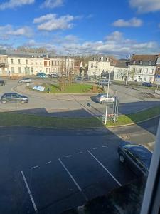 a parking lot with cars parked in a parking lot at Appartement calme, emplacement stratégique, proche de toutes commodités, de l'autoroute, valenciennes, lille, Belgique, wifi, Netflix, parking Gratuits, lave linge, sèche linge in Raismes