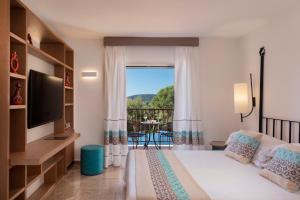 Postel nebo postele na pokoji v ubytování El Faro Hotel & Spa