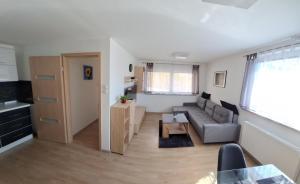 a living room with a couch and a table at APARTMENT BELkA in Jesenice