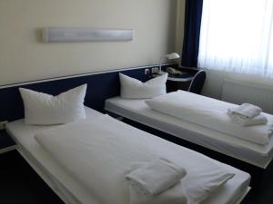 Säng eller sängar i ett rum på Central-Hotel Eberswalde