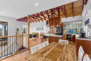 a kitchen and living room with a wooden table in it at Amazing Location with Ocean View in Cowes